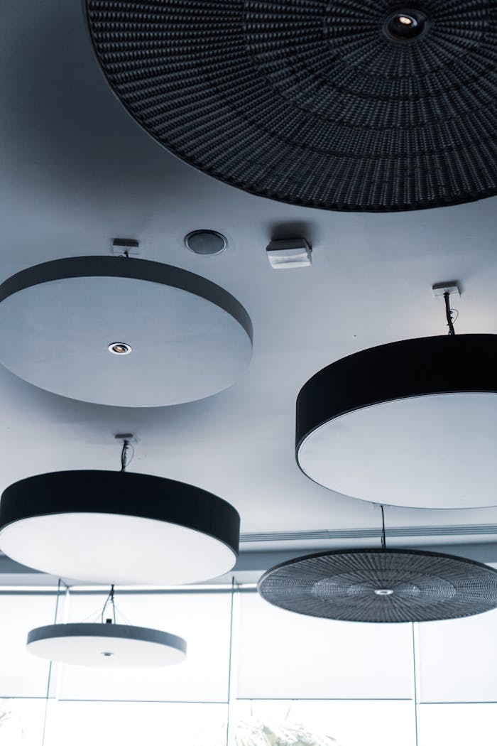 Circular ceiling lights in a modern design setting, showcasing contemporary lighting aesthetics.